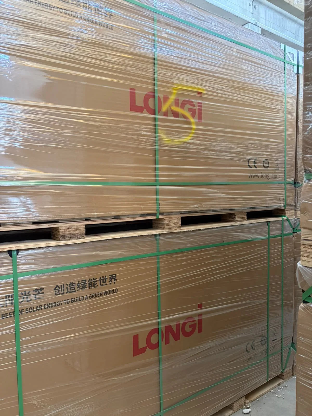 Longi solar module stock wrapped and secured for transport.