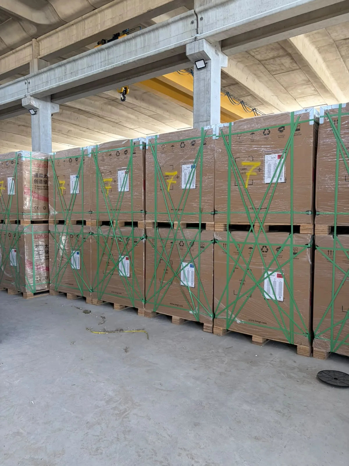 Stacked solar module pallets inside the warehouse.